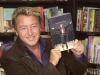 Michael Flatley poses proudly with a copy of Lord of the Dance. 