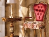 Majestically surrounded by gilded walls, this Florentine-inspired armchair and Italian-crafted table exudes a sumptuous rest. 