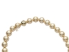 Embrace yourself in delicate femininity with a strand necklace that beams with Golden South Sea pearls. The 18-karat gold and diamond ball clasp adds a touch of gilded elegance. 