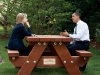 President Barack Obama and Secretary of State Hillary Rodham Clinton speak together sitting at a picnic table