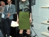 Model wears a green wool skirt paired with a snake-patterned silk shell under a black cashmere cardigan. This Boss Black ensemble is polished off with black knee-high chain boots and belt, Photos By George Pimentel/WireImage 