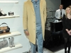 Model in a camel-coloured coat over a grey knit shirt and tie with a light grey flannel trouser and brown loafers, all from the Boss Black collection, Photos By George Pimentel/WireImage 