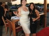 Two lovely ladies enjoy their martinis at a sophisticated red carpet affair.