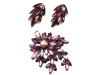 For a hint of glimmer, accessorize with this eye-catching pin, made with fuchsia stones and undulating glass beads. www.caroletanenbaum.com